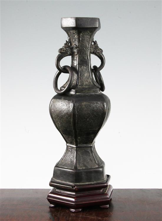 A Chinese archaistic bronze hexagonal baluster vase, Yuan dynasty, 30cm, wood stand